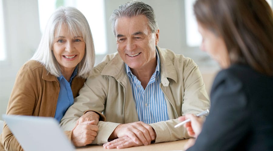 Older couple discussing dental and vision insurance with an agent.