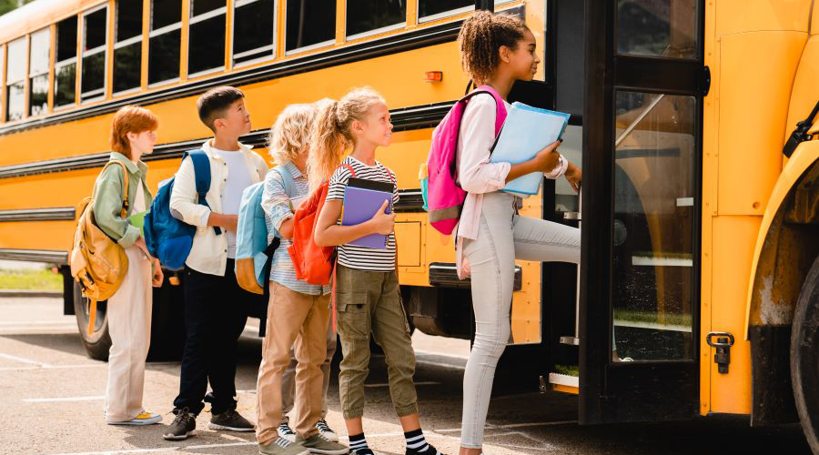 Children Getting On School Bus